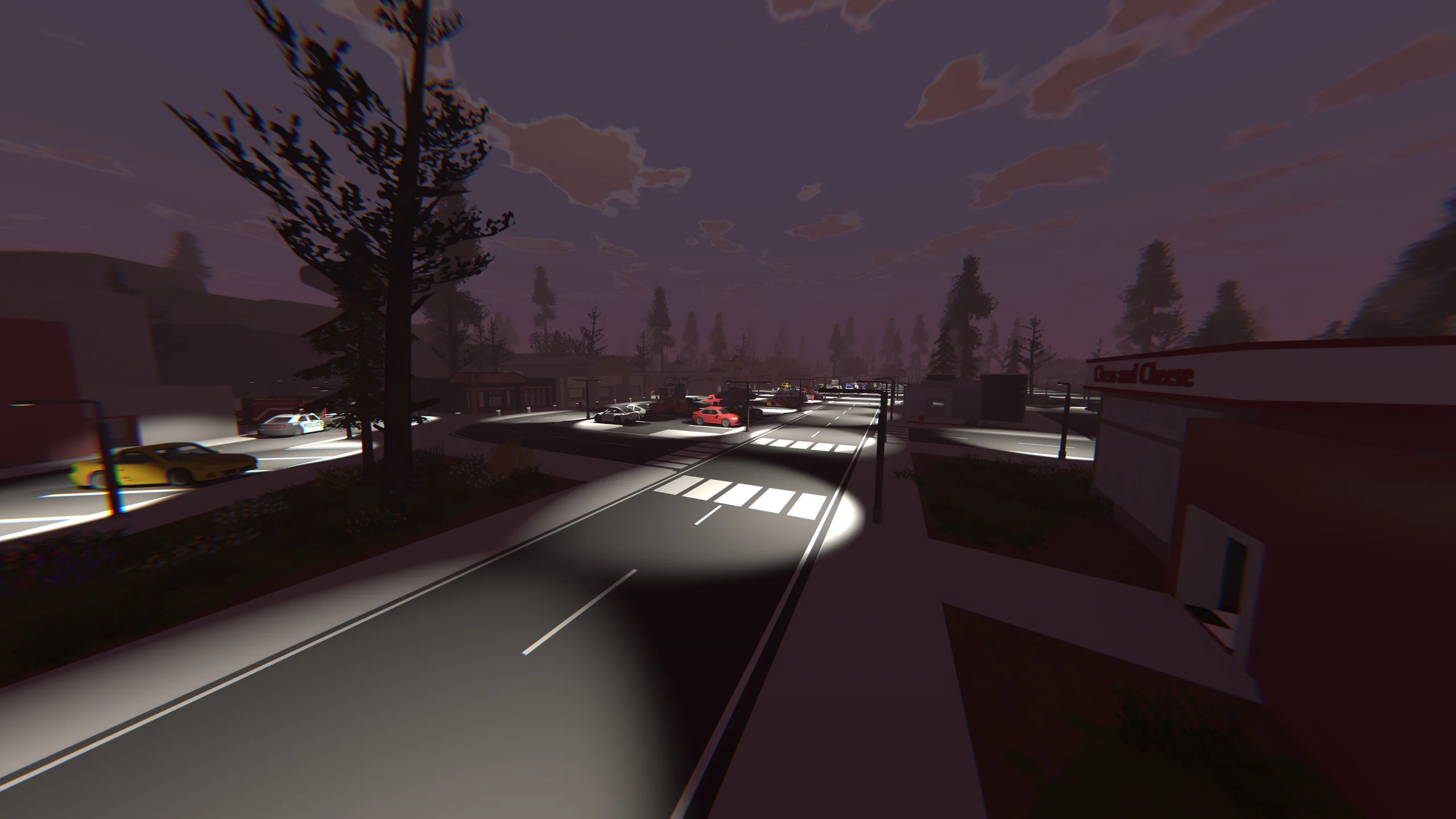 Night highway scene: cars with headlights on a curving road beside a red-lit building